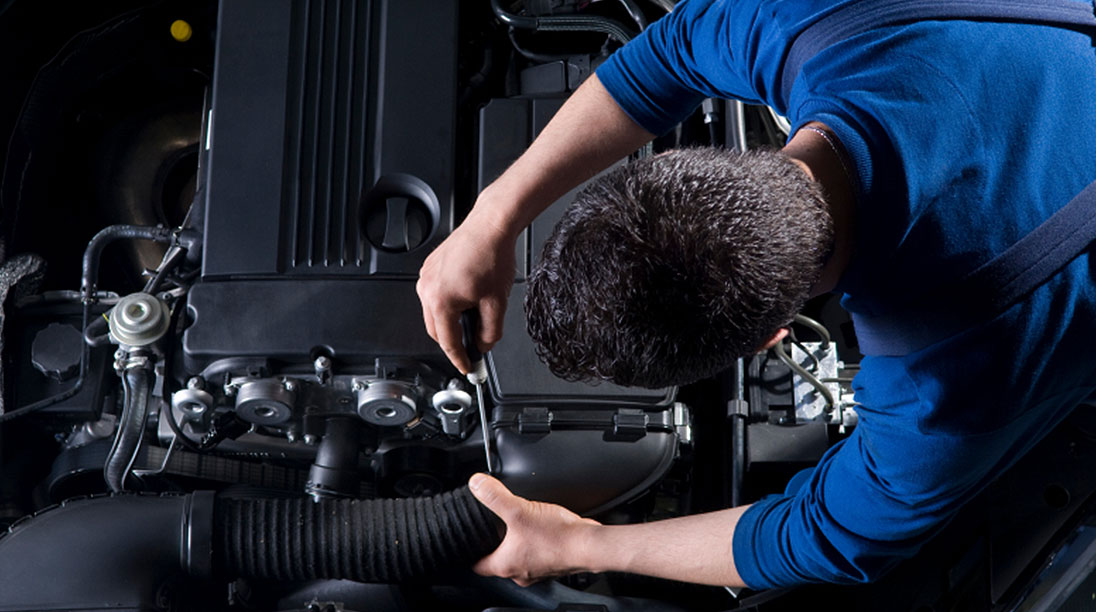 Mechanic working on car engine