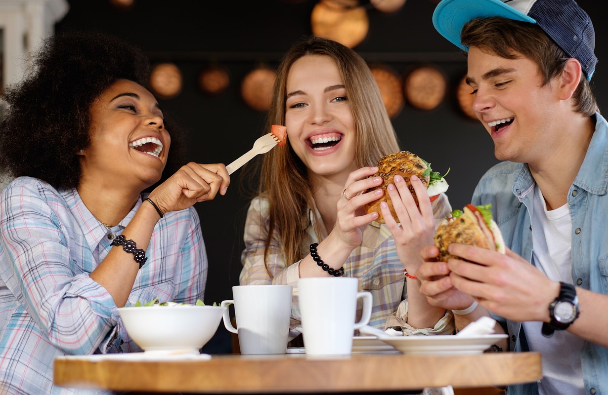 friends eating chicken burgers