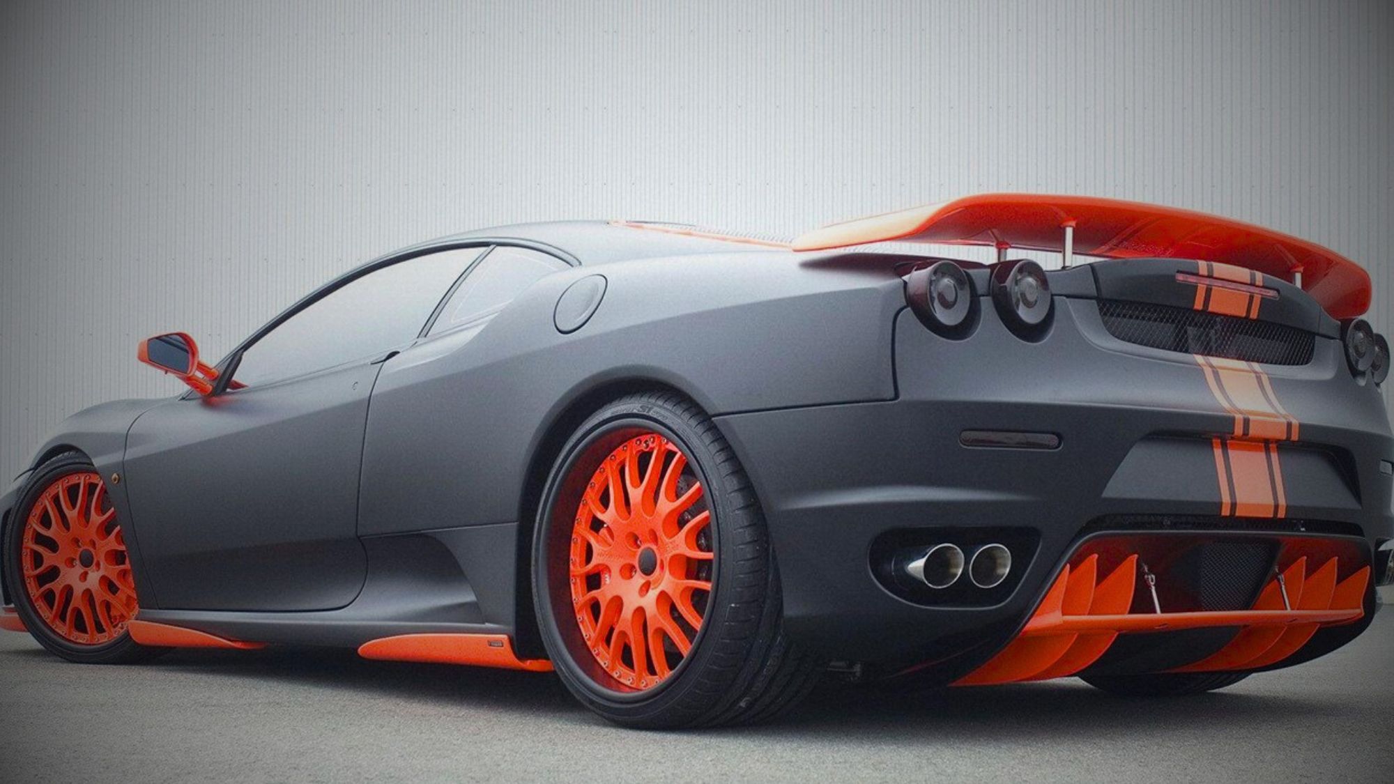 A black and orange sports car with orange stripes, showcasing modifying a vehicle benefits